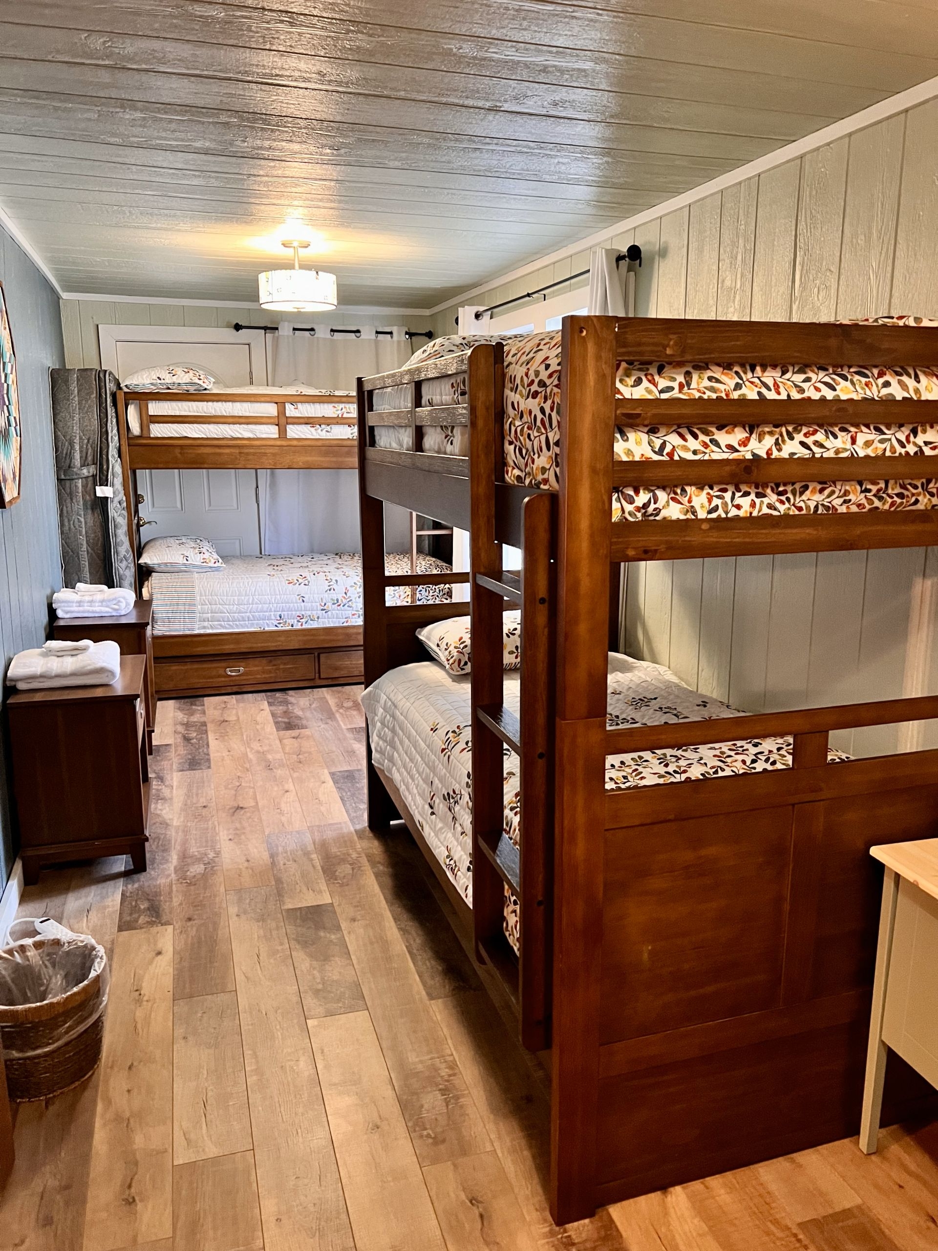 Bedroom with two sets of wooden bunk beds and finished wood floors